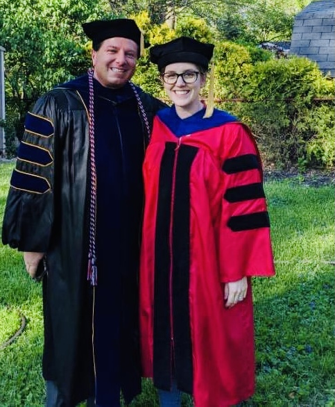 Brian Calfano celebrating the hooding of his Ph.D. student, Dr. Alexis Straka, 2021